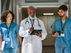 a doctor and two nurses walk together
