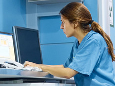 Nurse working on computer in hospital