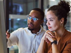 IT team members look at platform on desktop