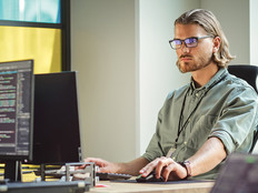 IT person looks at computer screen filled with code