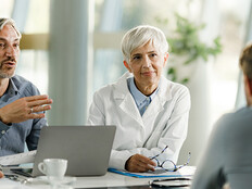 Team of doctors and businessmen having a meeting
