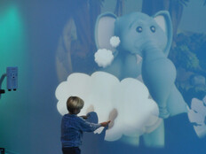 child plays with projection at hospital