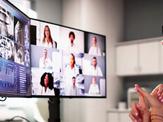doctor on video call with several care team members