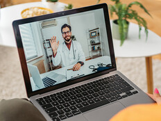 patient on laptap doing a telehealth call with doctor