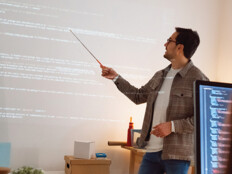 man teaches coding class using projector