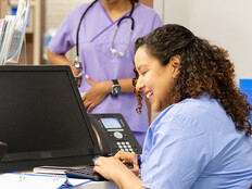Nurse working at the front desk of a hospital