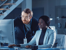 IT team confers over monitor