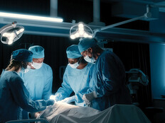 doctors perform surgery in a dark room