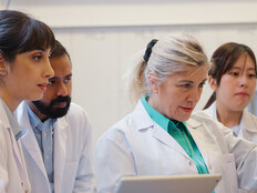 doctors gathered around computer