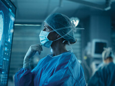 Surgeon looks at brain on a display in the OR