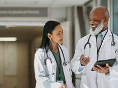 two doctors smile as they walk