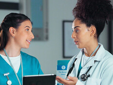 nurse and doctor collaborate over tablet