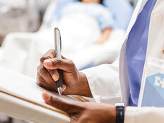 doctor uses paper charting in front of patient