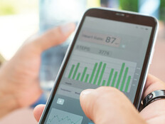 person with wearable ring checks app on phone