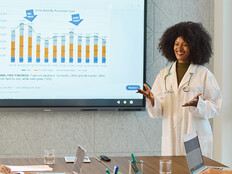 doctor gives presentation in front of chart