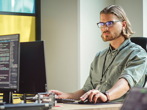 IT person looks at computer screen filled with code