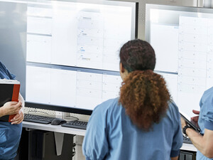 Doctors reviewing information boards