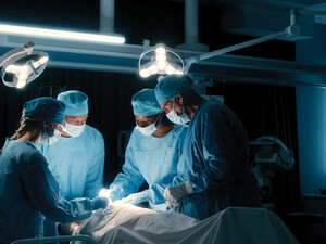 doctors perform surgery in a dark room