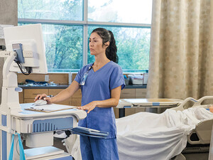 nurse on laptop in patient room
