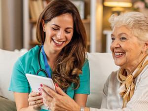 nurse and senior look at technology