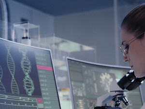 scientist looks at DNA on a computer