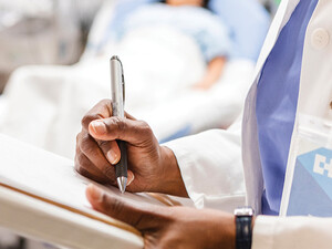 doctor uses paper charting in front of patient