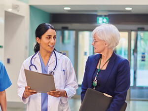 Hospital workers walking down a hallway