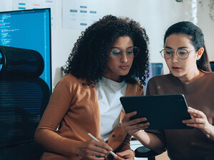 two IT leaders read document on tablet