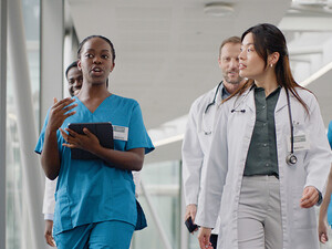 clinicians walking in hospital hallway