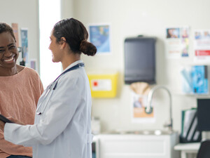 doctor and patient smiling at appointment