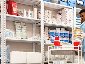 man grabs supplies in pharmacy supply room