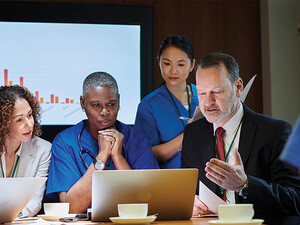 healthcare leaders meet around table