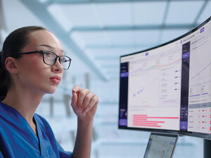 clinician looks at data on a monitor