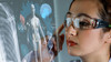 Young female doctor looking at hologram screen