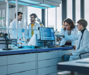 researchers evaluate clinical trial data in lab