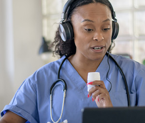 Nurse working with patient via telehealth