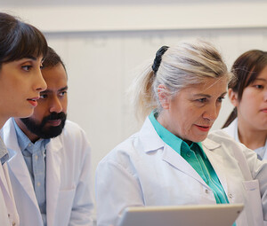doctors gathered around computer