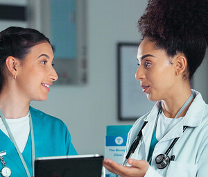 nurse and doctor collaborate over tablet