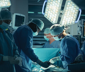 medical team performs surgery in dark room
